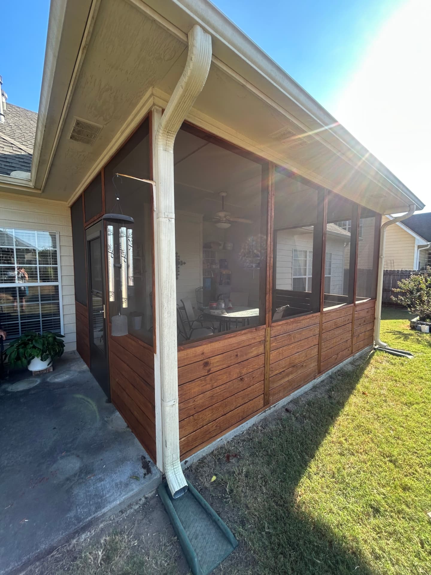 New screened porch enclosure with stained wood panels